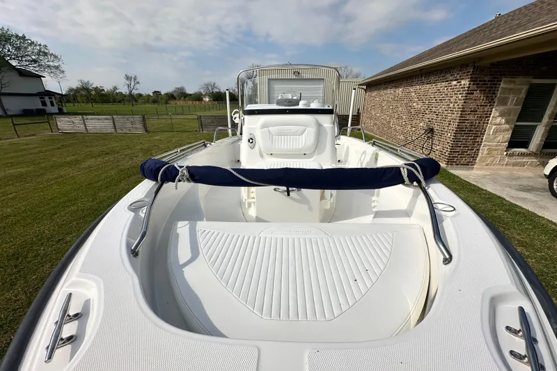 Slide: The Image of 2008 Boston Whaler 180 Dauntless boat on grass, showcasing spacious deck and sleek design. - 23