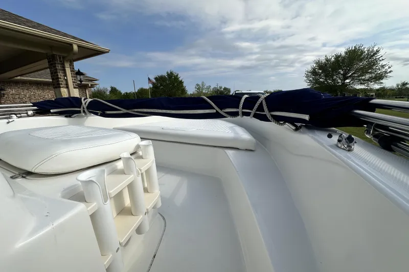 Slide: The Image of 2008 Boston Whaler 180 Dauntless boat interior with white seating and blue cover. - 26
