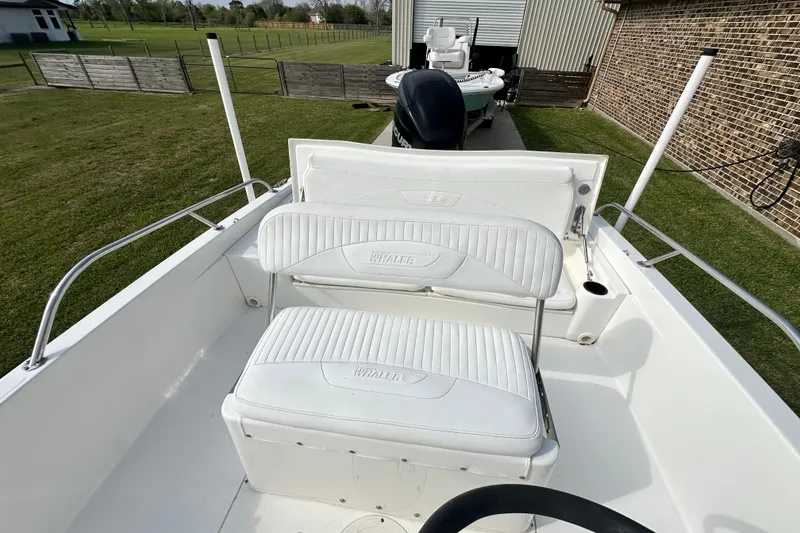 Slide: The Image of 2008 Boston Whaler 180 Dauntless boat interior with white seating and steering wheel. - 28
