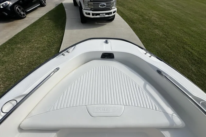 Slide: The Image of 2008 Boston Whaler 180 Dauntless boat bow view, parked on driveway near truck. - 31