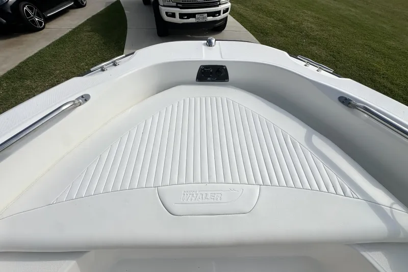 Slide: The Image of 2008 Boston Whaler 180 Dauntless boat interior with white cushioned seating and stainless steel rails. - 32