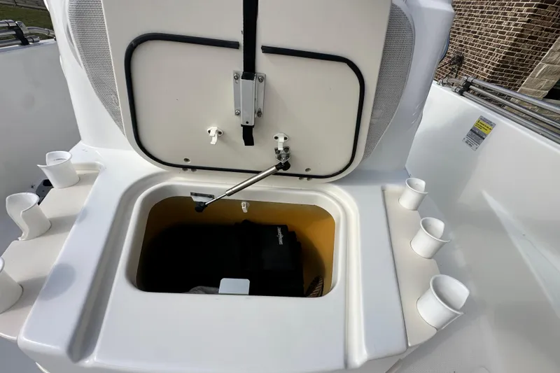 Slide: The Image of Open storage compartment on 2008 Boston Whaler 180 Dauntless boat with cup holders. - 34