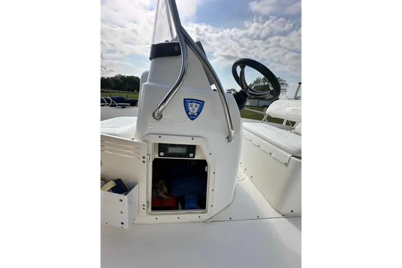 Slide: The Image of 2008 Boston Whaler 180 Dauntless boat console with storage compartment and steering wheel. - 35