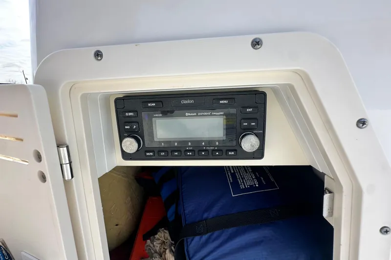 Slide: The Image of Clarion stereo system inside a 2008 Boston Whaler 180 Dauntless boat compartment. - 36