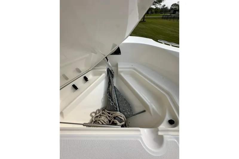 Slide: The Image of Open anchor storage on 2008 Boston Whaler 180 Dauntless boat, featuring rope and anchor. - 38