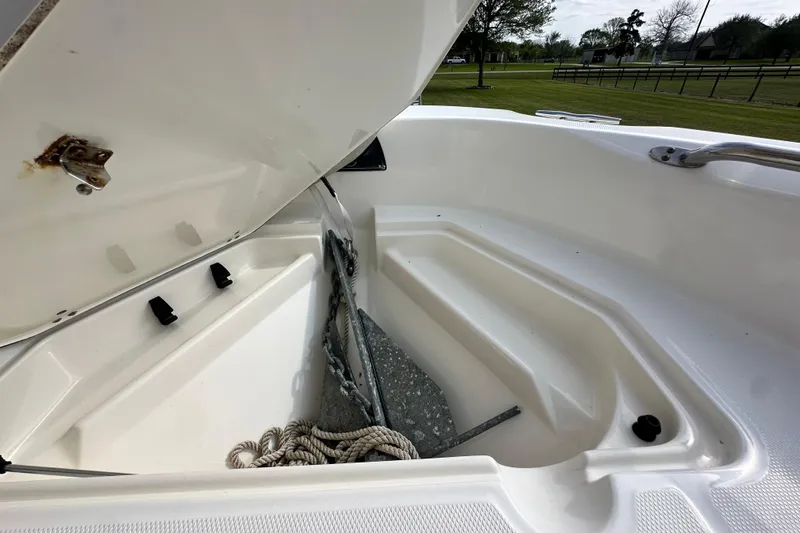 Slide: The Image of Open anchor compartment on 2008 Boston Whaler 180 Dauntless boat, showing anchor and rope. - 39
