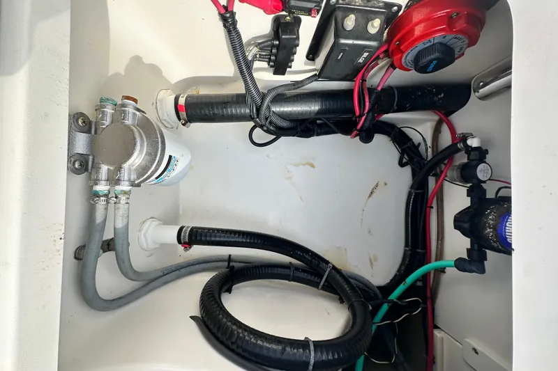 Slide: The Image of 2008 Boston Whaler 180 Dauntless boat wiring and plumbing compartment, showcasing cables and components. - 41