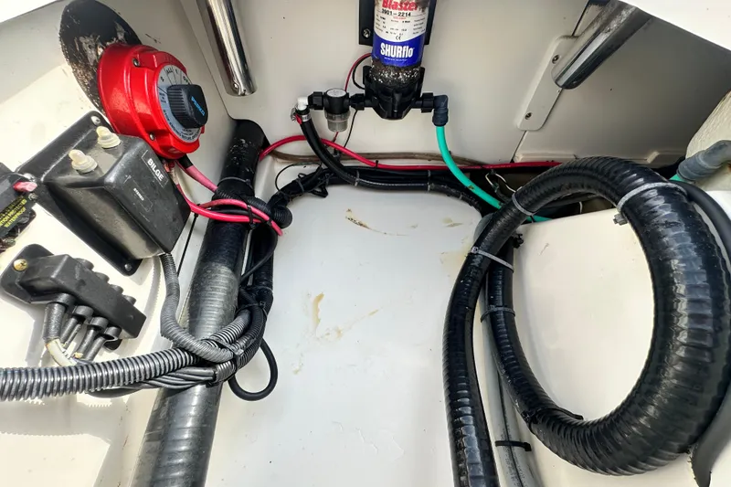 Slide: The Image of Electrical and plumbing components inside a 2008 Boston Whaler 180 Dauntless boat. - 42