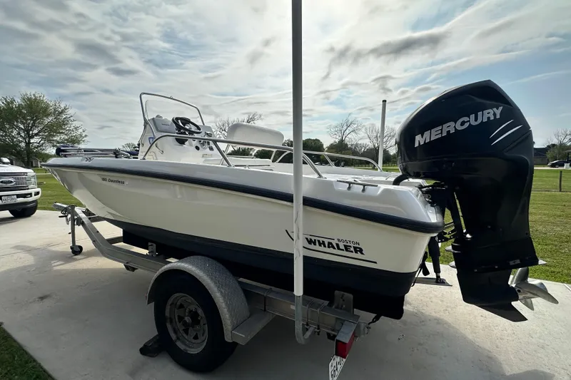 Slide: The Image of 2008 Boston Whaler 180 Dauntless boat on trailer with Mercury outboard motor. - 5