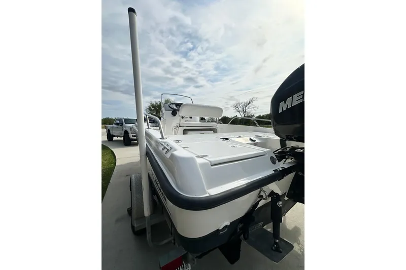 Slide: The Image of 2008 Boston Whaler 180 Dauntless boat on trailer, parked outdoors under cloudy sky. - 8