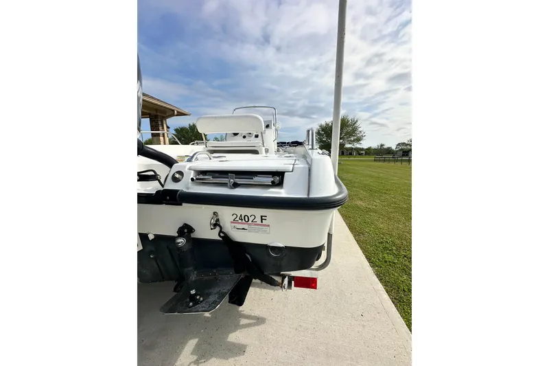 Slide: The Image of 2008 Boston Whaler 180 Dauntless boat rear view on concrete driveway. - 9