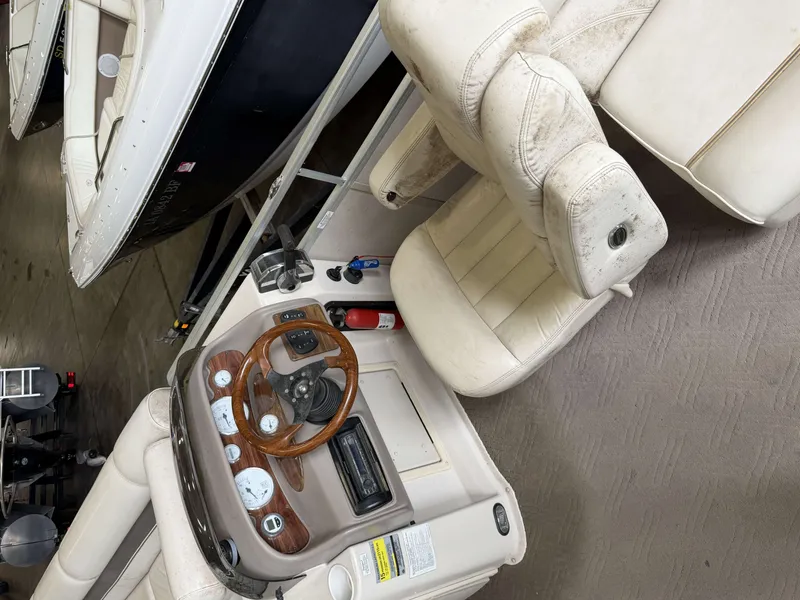 Slide: The Image of Interior of a 2003 Premier 270 Grand Majestic boat with steering console. - 19