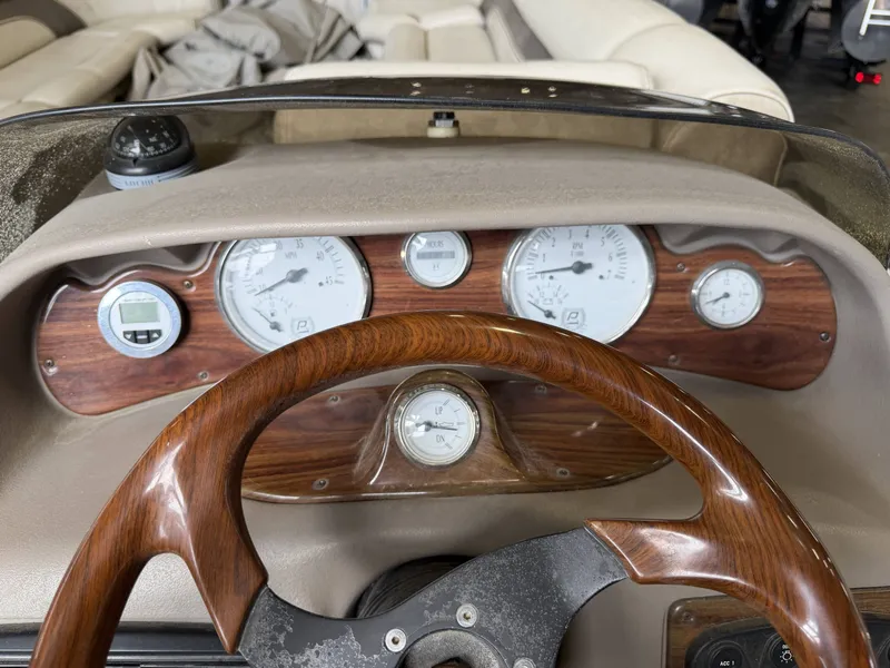Slide: The Image of Dashboard of a 2003 Premier 270 Grand Majestic boat with wooden steering wheel. - 21