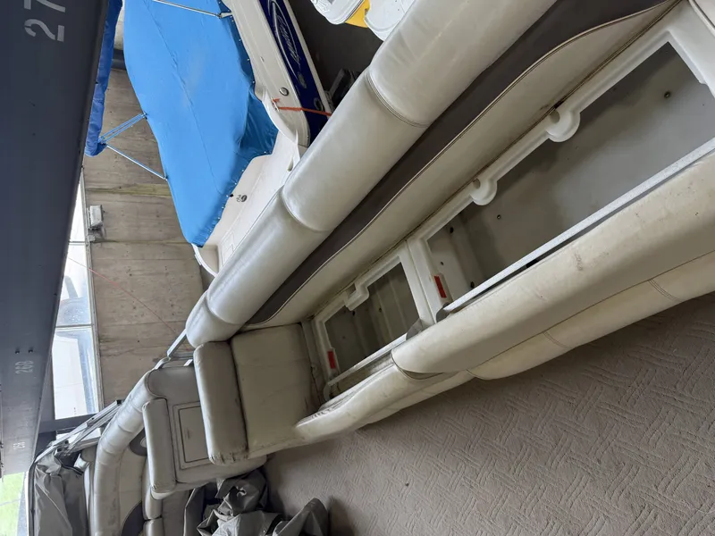 Slide: The Image of Interior of a 2003 Premier 270 Grand Majestic boat with blue covers. - 31