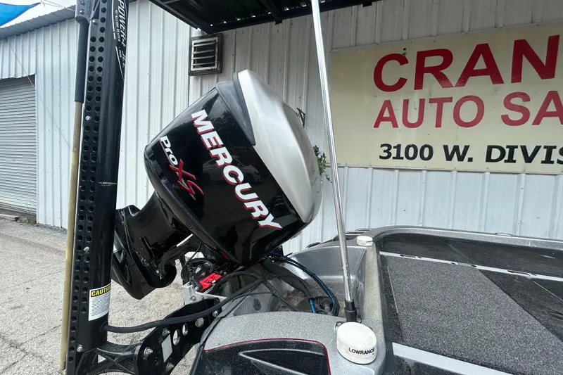 Slide: The Image of 2008 Ranger Z22 Comanche fishing boat with dual seats, Humminbird electronics, and Mercury engine by the lake. - 27