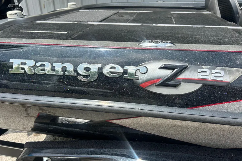 Slide: The Image of 2008 Ranger Z22 Comanche boat on trailer, parked outdoors, featuring sleek black design. - 7
