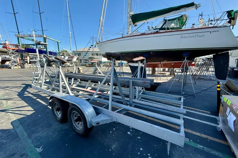 Slide: The Image of Boat yard with 2003 Alerion Express 28 sailboat on stands, trailer in foreground. - 19
