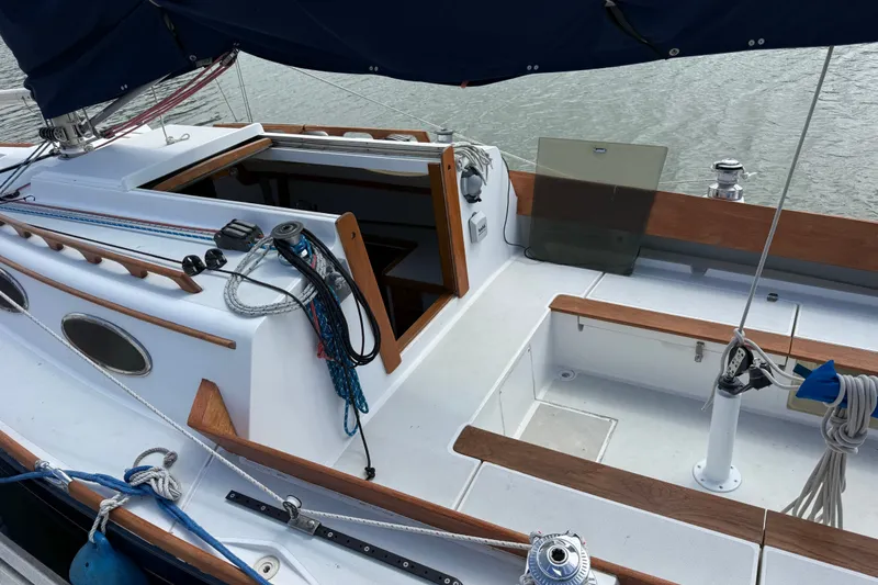 Slide: The Image of Cockpit of a 2003 Alerion Express 28 sailboat with wooden trim and nautical equipment. - 8