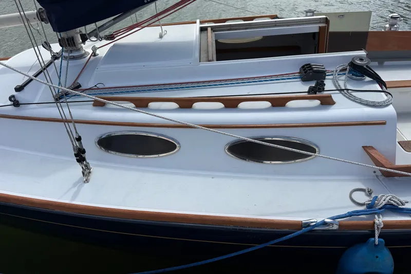 Slide: The Image of 2003 Alerion Express 28 sailboat deck with ropes and portholes. - 10
