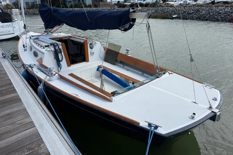 Slide: The Image of 2003 Alerion Express 28 sailboat docked in a marina, featuring a sleek design. - 7