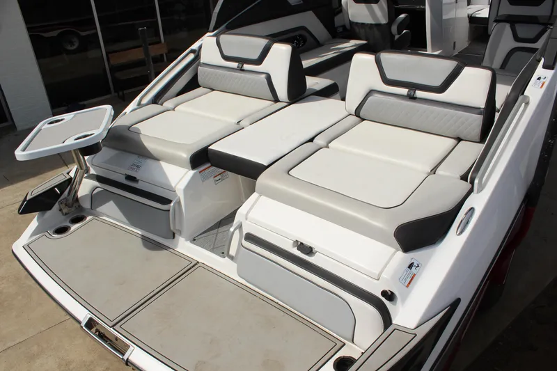 Slide: The Image of 2020 Yamaha Boats 275SE interior with cushioned seating and table, showcasing luxury design. - 8