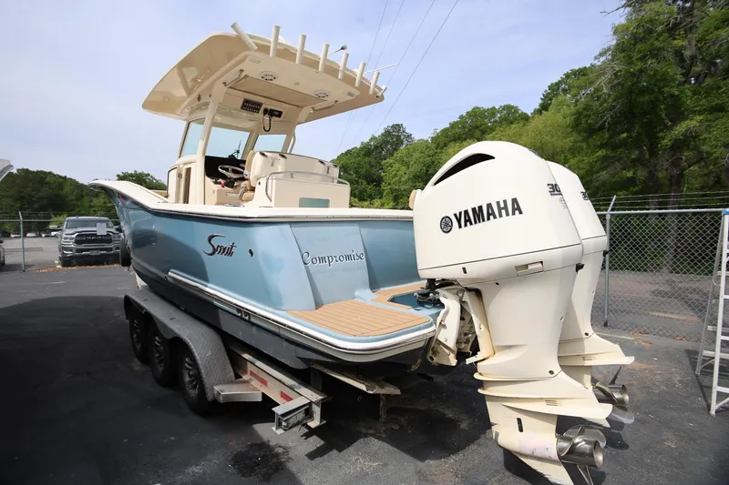 Slide: The Image of 2018 Scout 300 LXF boat with Yamaha engines on a trailer. - 12
