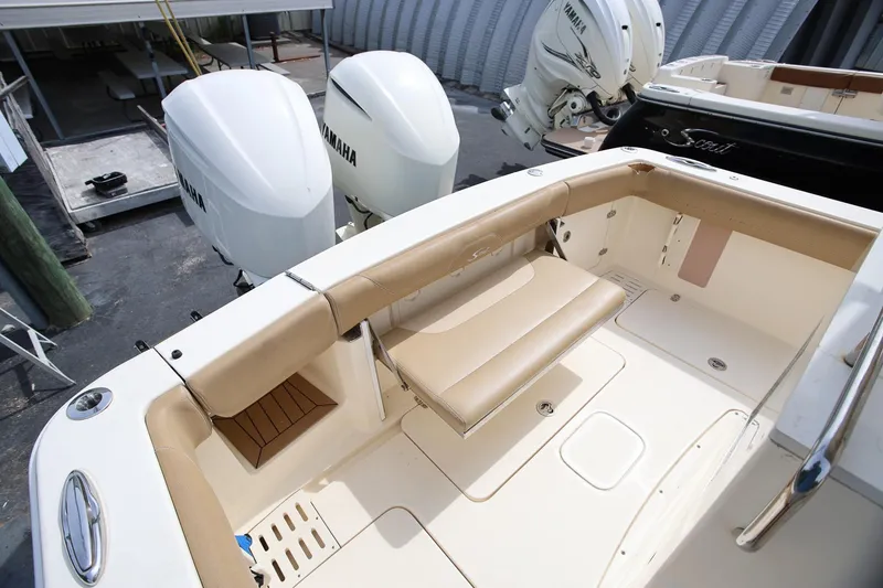 Slide: The Image of 2018 Scout 300 LXF boat with Yamaha engines, featuring beige seating and spacious deck area. - 14