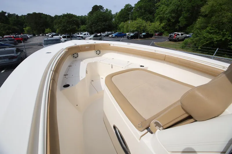 Slide: The Image of 2018 Scout 300 LXF boat interior with beige seating and spacious deck. - 20