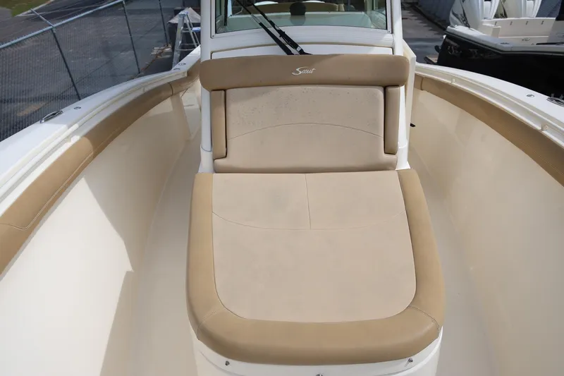 Slide: The Image of 2018 Scout 300 LXF boat with beige seating and sleek design. - 22