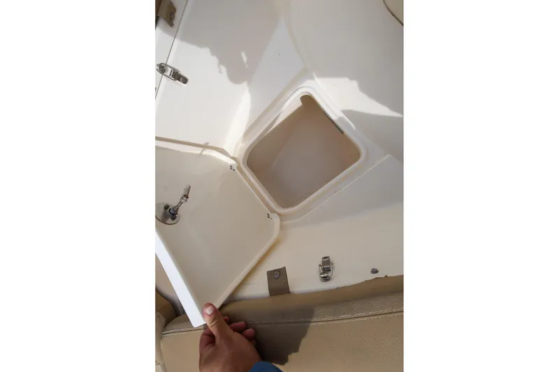 Slide: The Image of Open storage compartment on a 2018 Scout 300 LXF boat, showing interior details. - 26