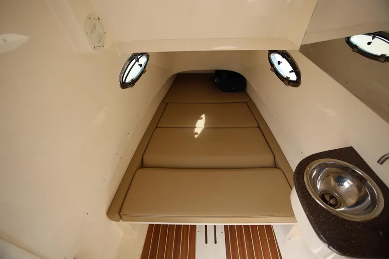Slide: The Image of 2018 Scout 300 LXF cabin interior with beige cushions and stainless steel sink. - 27