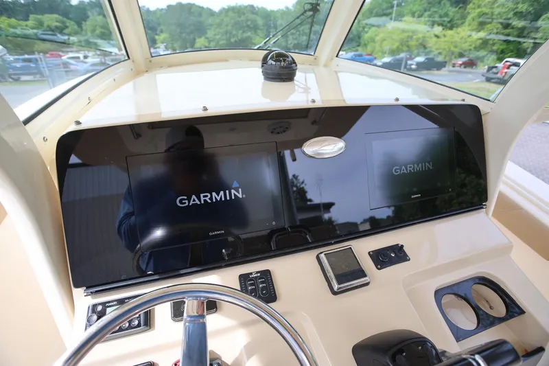 Slide: The Image of 2018 Scout 300 LXF boat dashboard with Garmin navigation displays. - 31