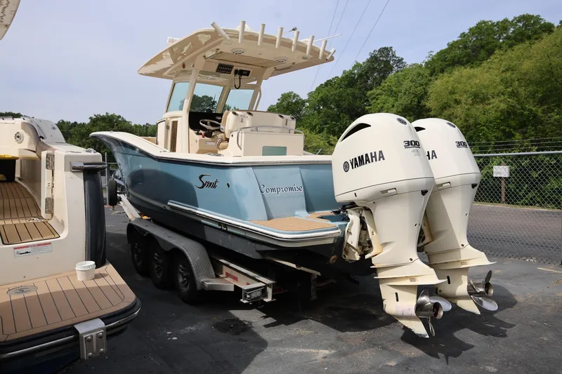 Slide: The Image of 2018 Scout 300 LXF boat with twin Yamaha engines on a trailer. - 5