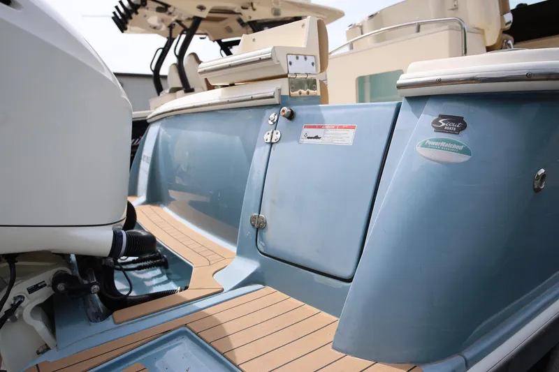 Slide: The Image of 2018 Scout 300 LXF boat stern with outboard motor and teak flooring. - 9