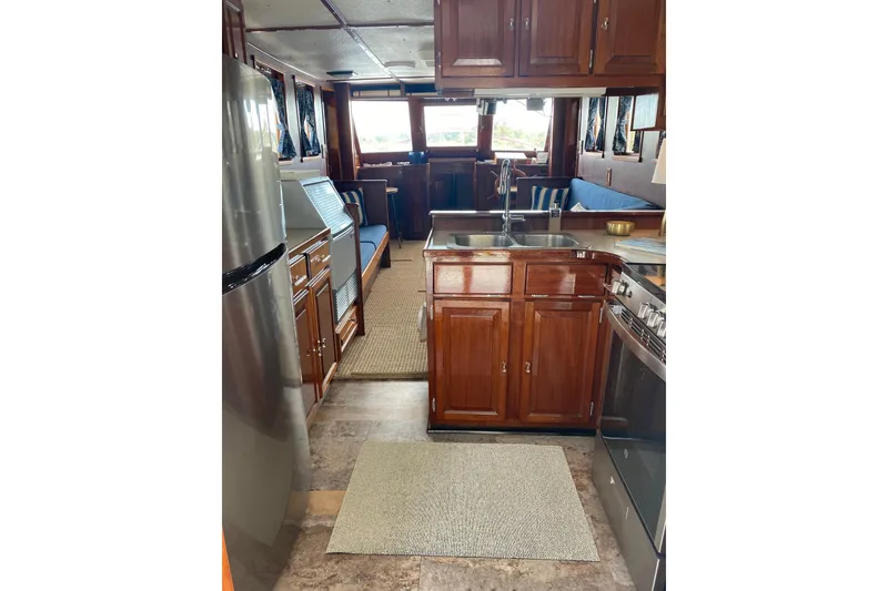 Slide: The Image of Interior of a 1996 Bill Holland trawler with wooden cabinetry and modern appliances. - 10