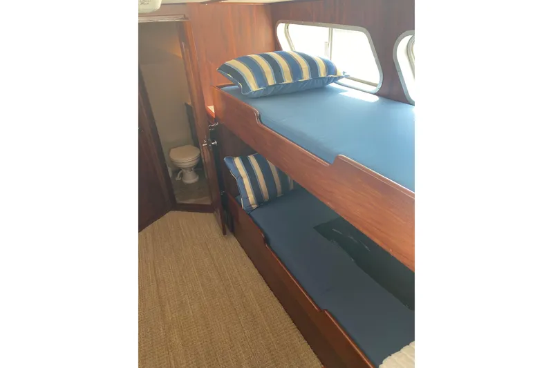 Slide: The Image of Interior of 1996 Bill Holland trawler with bunk beds and adjacent bathroom. - 3