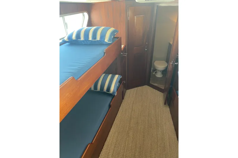 Slide: The Image of Interior of 1996 Bill Holland trawler with bunk beds and bathroom. - 4