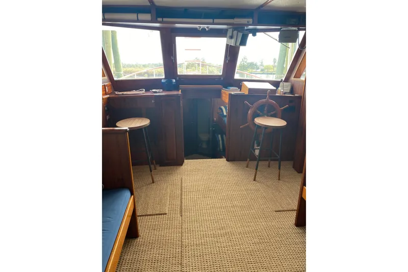 Slide: The Image of Interior of a 1996 Bill Holland trawler with wooden helm and stools. - 6