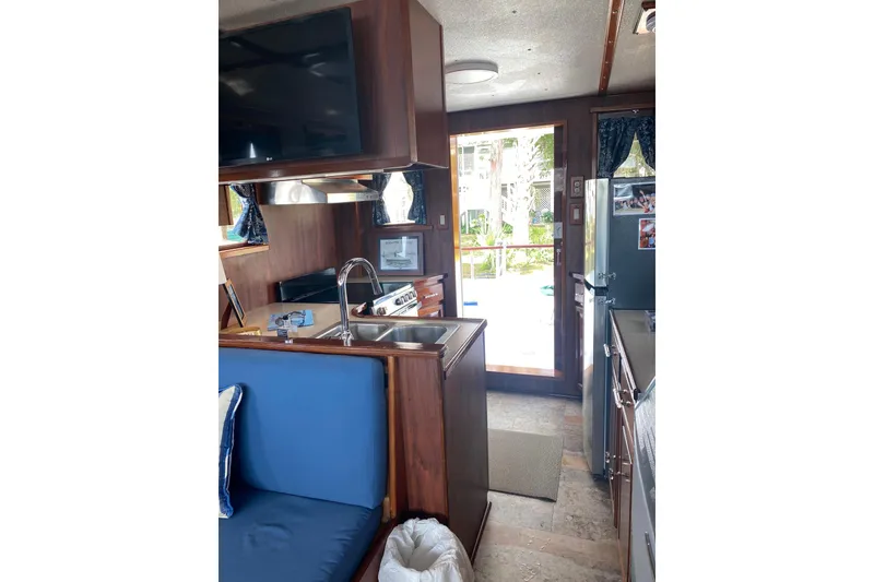 Slide: The Image of Interior of a 1996 Bill Holland trawler with kitchen and seating area. - 8