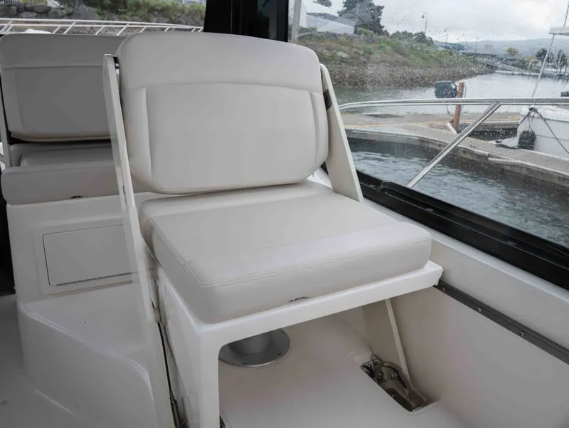 Slide: The Image of Interior of Boston Whaler 325 Conquest 2026 with beige seating. - 12