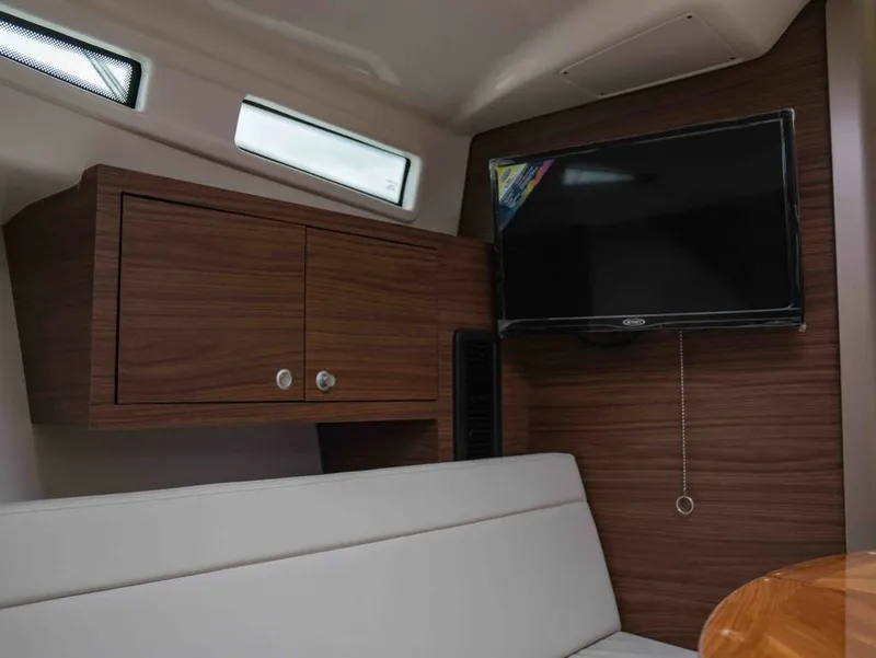 Slide: The Image of Interior of 2026 Boston Whaler 325 Conquest with TV and wood paneling. - 18