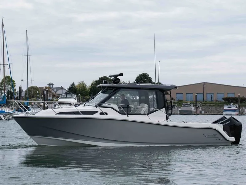 Slide: The Image of 2026 Boston Whaler 325 Conquest on calm harbor waters. - 24