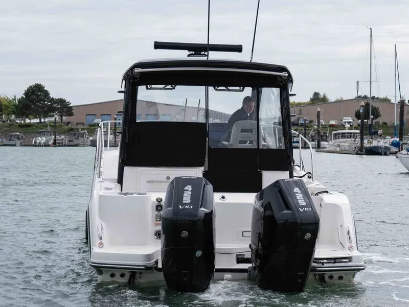 Slide: The Image of Rear view of 2026 Boston Whaler 325 Conquest on the water. - 6