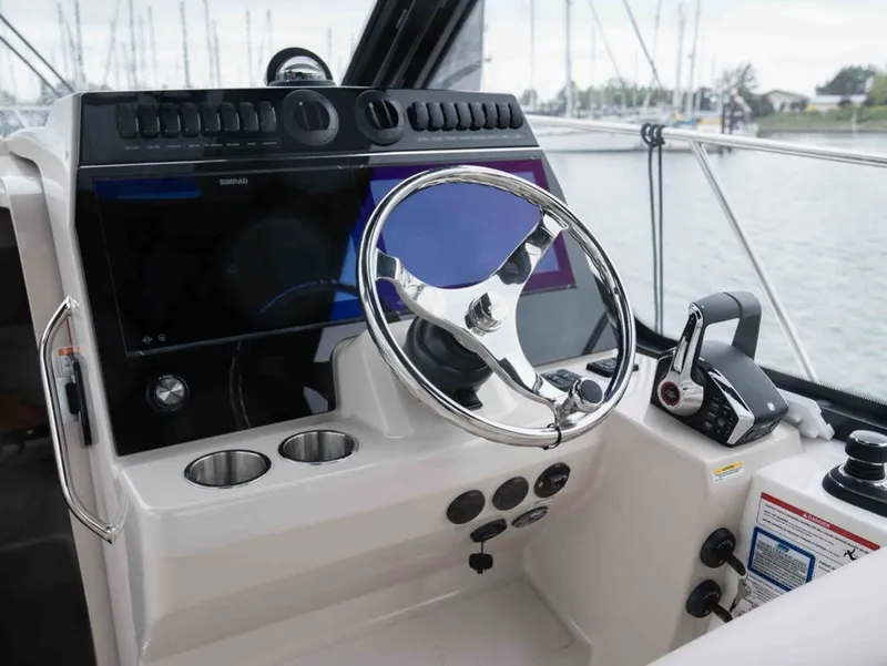 Slide: The Image of 2026 Boston Whaler 325 Conquest helm with modern electronics. - 8