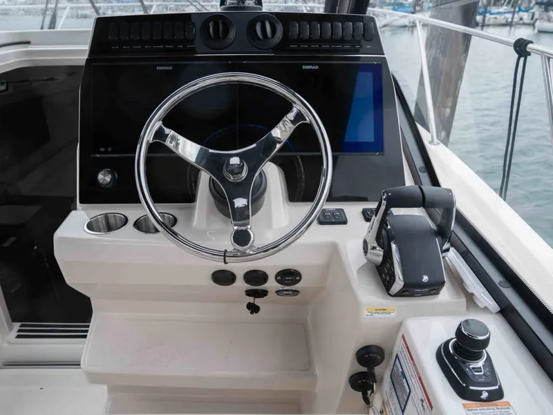 Slide: The Image of 2026 Boston Whaler 325 Conquest helm with modern electronics. - 9