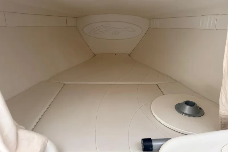 Slide: The Image of Interior cabin of a 1999 Baja 29 Outlaw boat, featuring beige upholstery. - 11