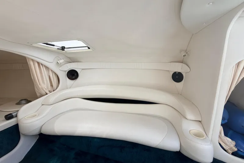 Slide: The Image of Interior of a 1999 Baja 29 Outlaw boat with white seating and speaker system. - 12