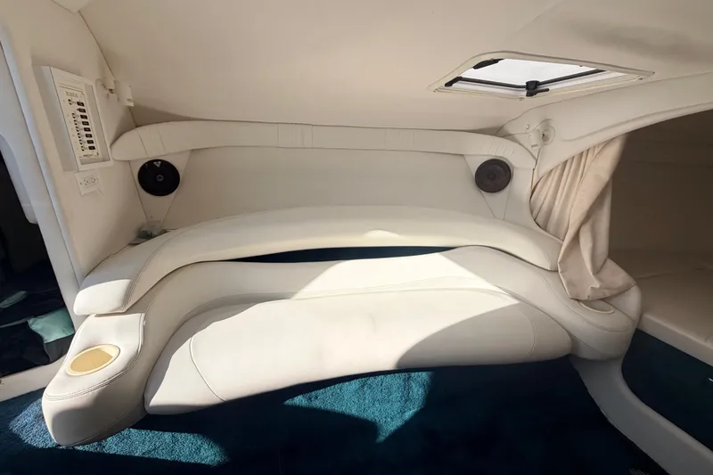 Slide: The Image of Interior of a 1999 Baja 29 Outlaw boat with white seating and blue carpet. - 13