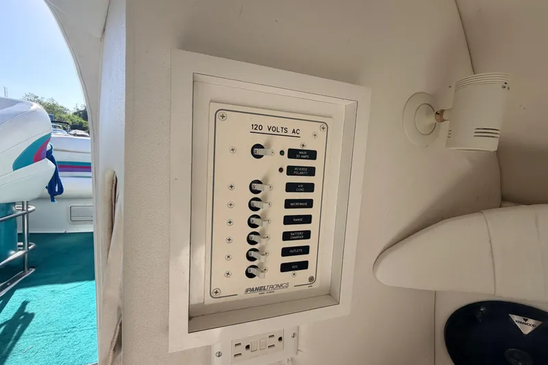 Slide: The Image of 1999 Baja 29 Outlaw boat interior showing 120 volts AC control panel. - 14