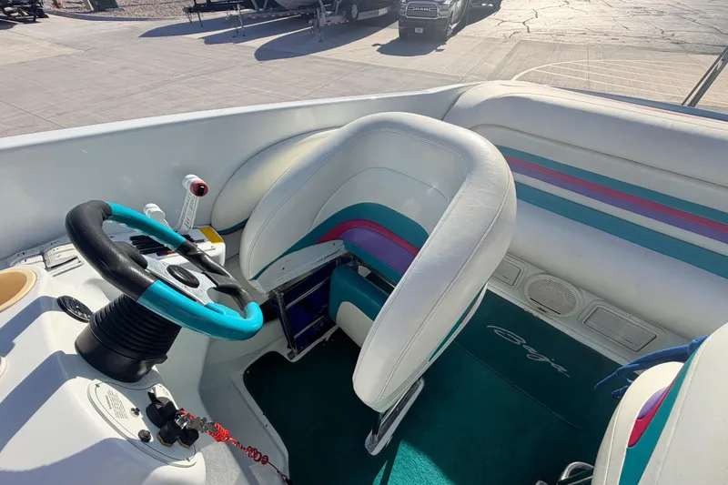 Slide: The Image of 1999 Baja 29 Outlaw boat interior with colorful steering wheel and seating. - 17